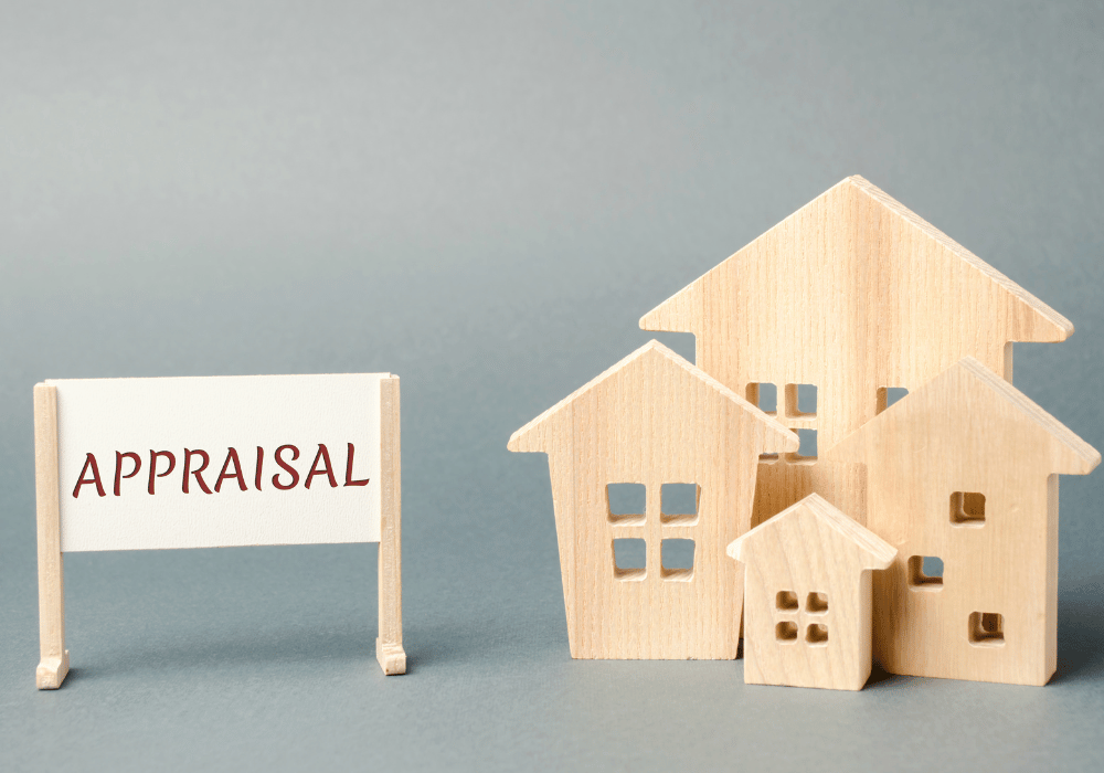 Wooden toy houses beside a small sign reading Appraisal